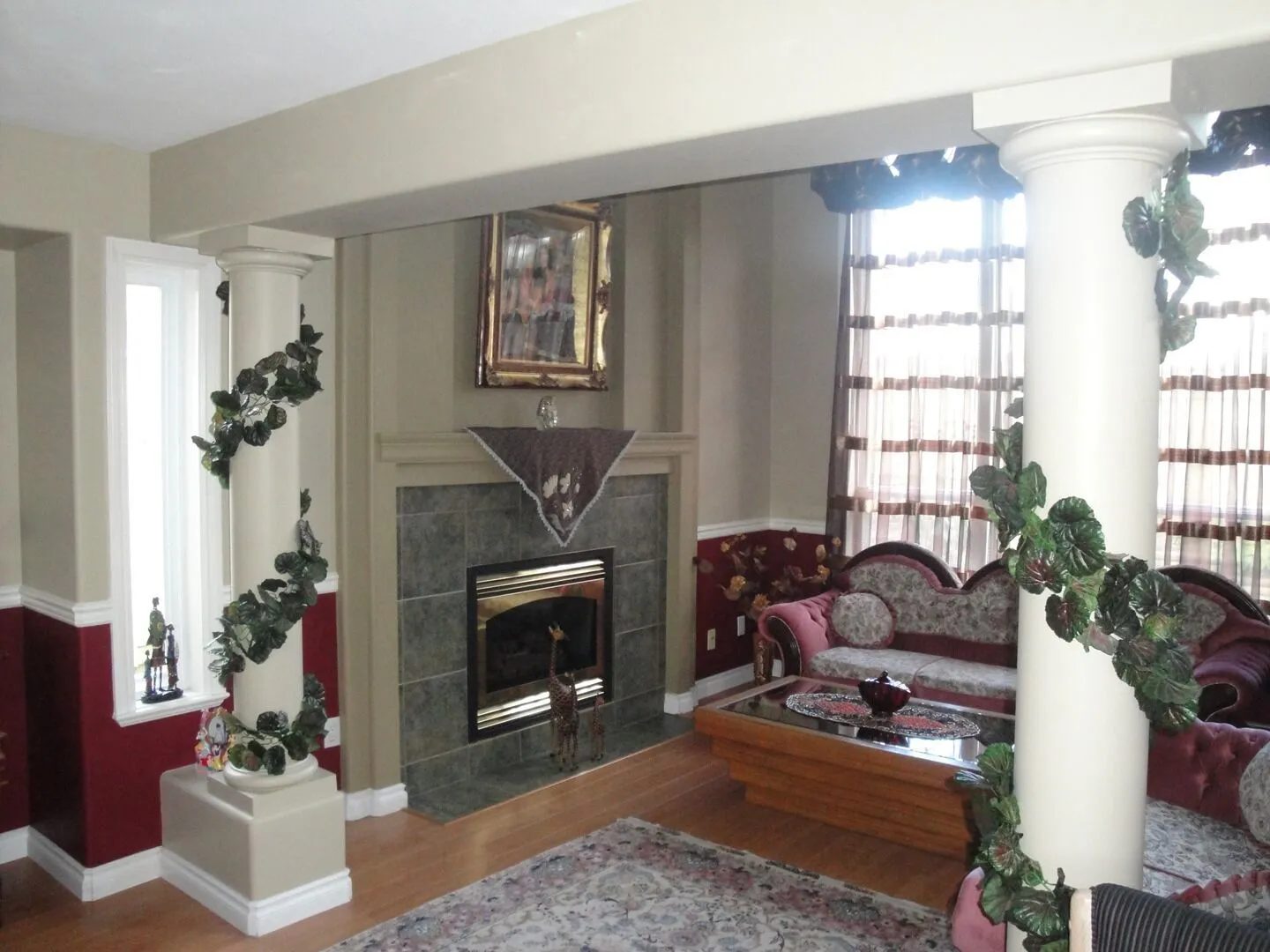 Living room with painted columns, trim and a two-tone wall